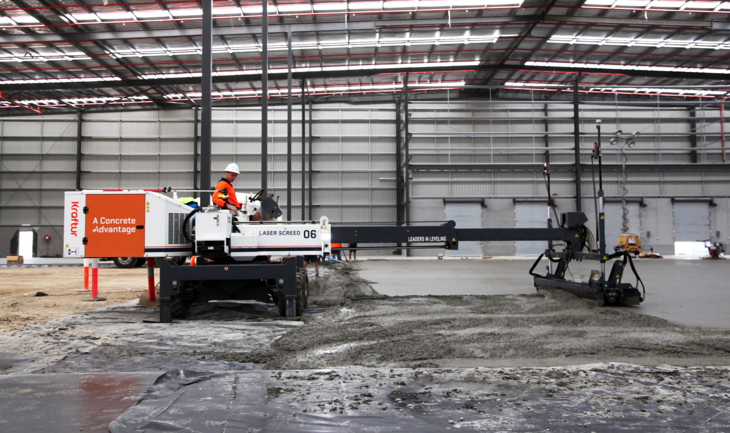 A Somero laser screed placing concrete on a job site