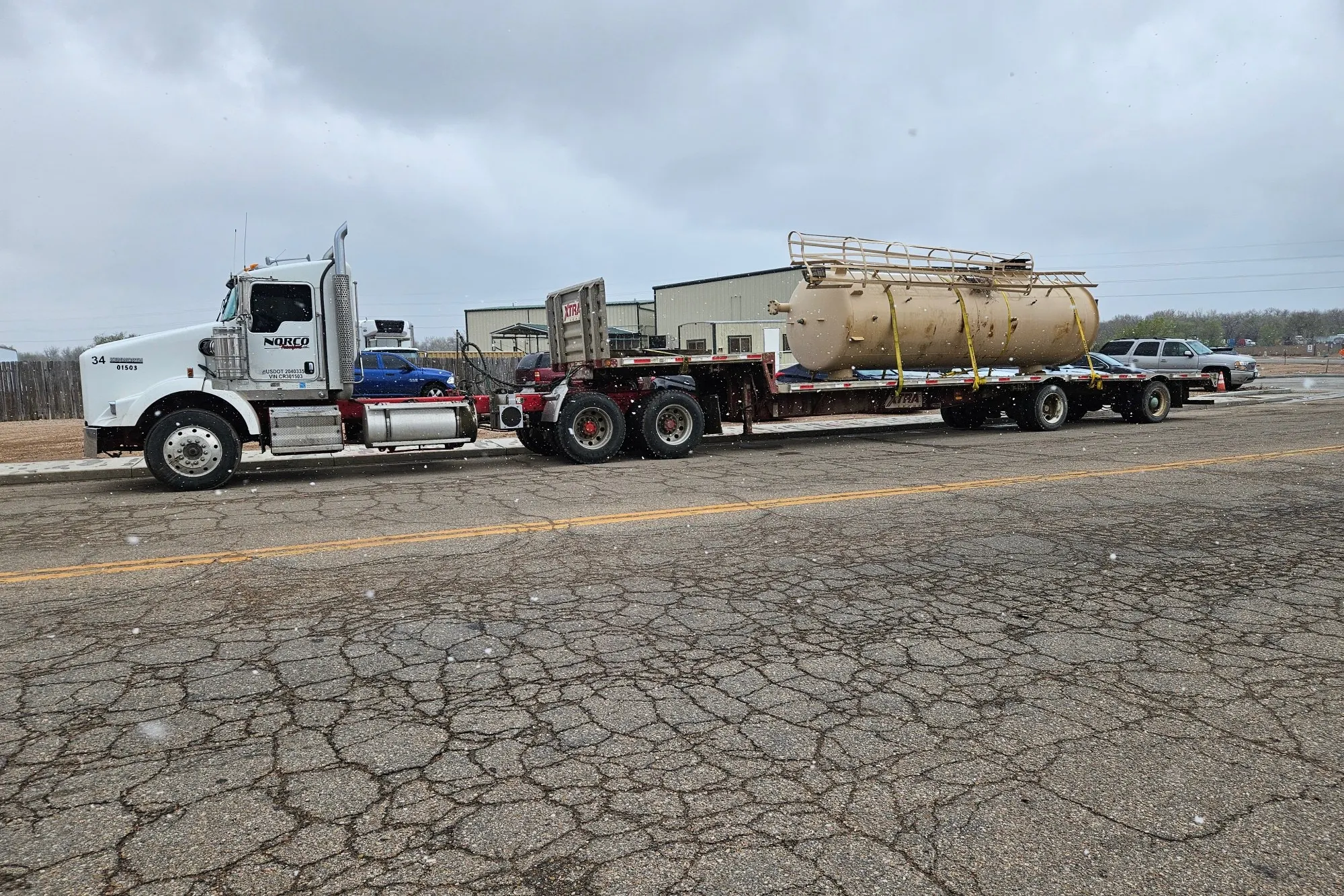 A Norco Transport truck hauling a treater on a flatbed